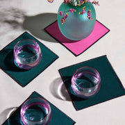 ATELIER SAUCIER - Bird of Paradise Cocktail Napkins | Set of 4, showcasing vibrant coasters with a teal vase and blossoms, echoing tropical elegance, ideal for sophisticated kitchen settings.