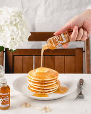 Runamok Mini Sparkle Syrup 60ml bottle pours over pancakes, showcasing its amber glow, perfect for elevating breakfast or gifting, available at Athens Cooks.