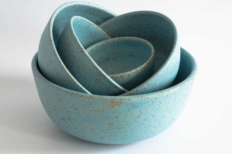 RachaelPots - Laura Bowl: Yellow, features four nesting speckled turquoise ceramic bowls, hand-thrown in Brooklyn, ideal for versatile meal presentations.