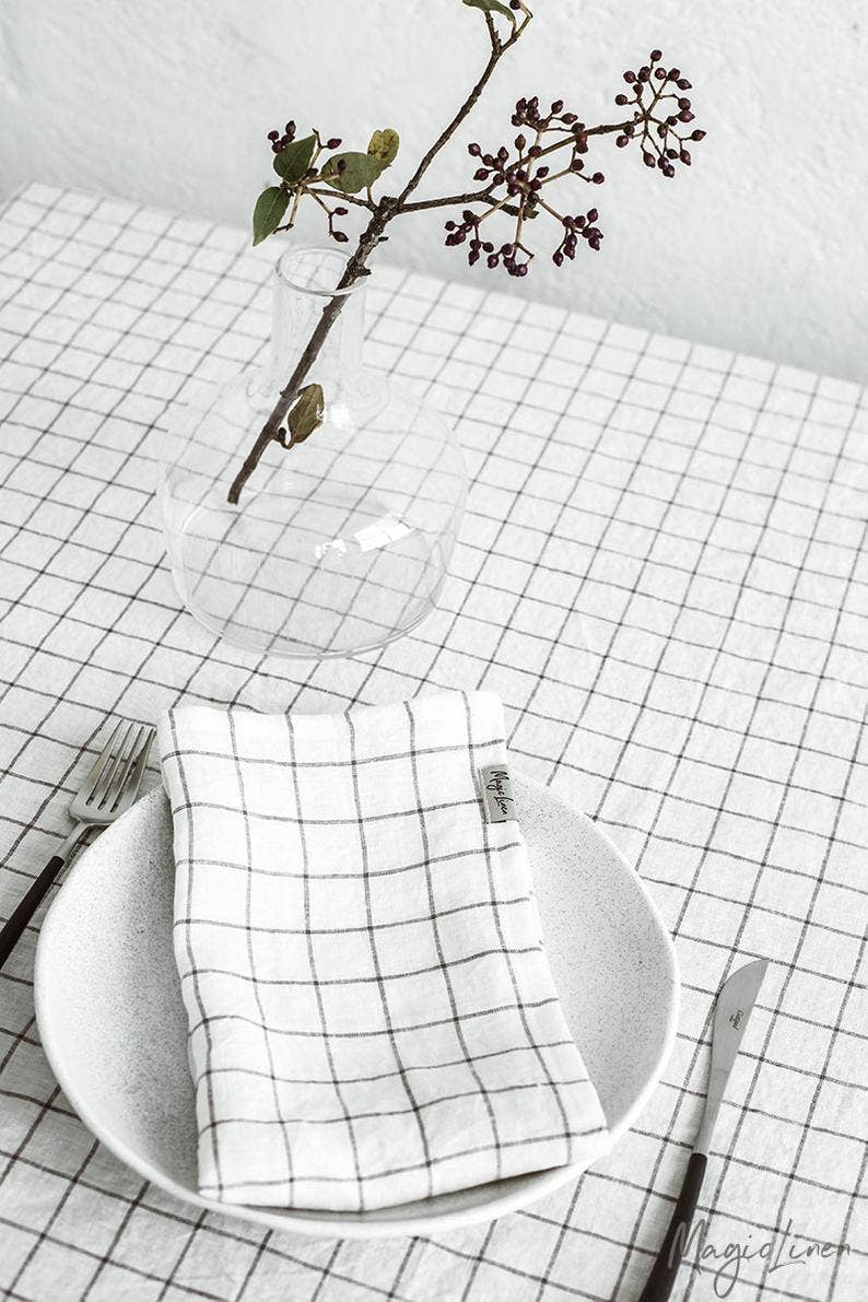 Set of 2 MagicLinen pure linen napkins, displayed on a table with plate and fork, ideal for versatile table decor.