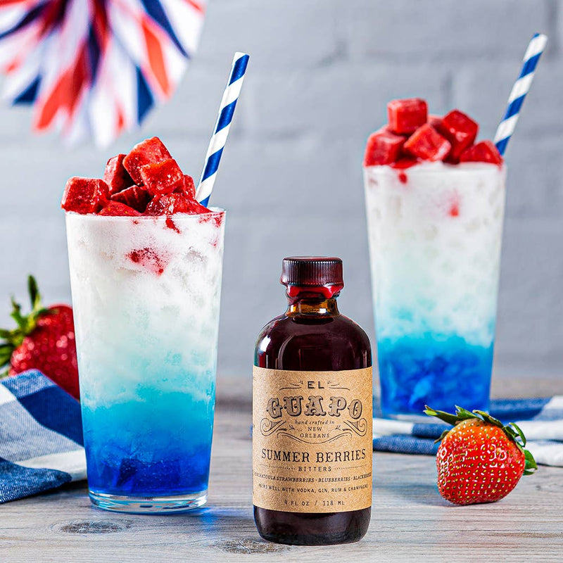 El Guapo - Bitters: Summer Berries, featuring two cocktails with blue and white striped straws, a Ponchatoula strawberry garnish, and a liquor bottle.