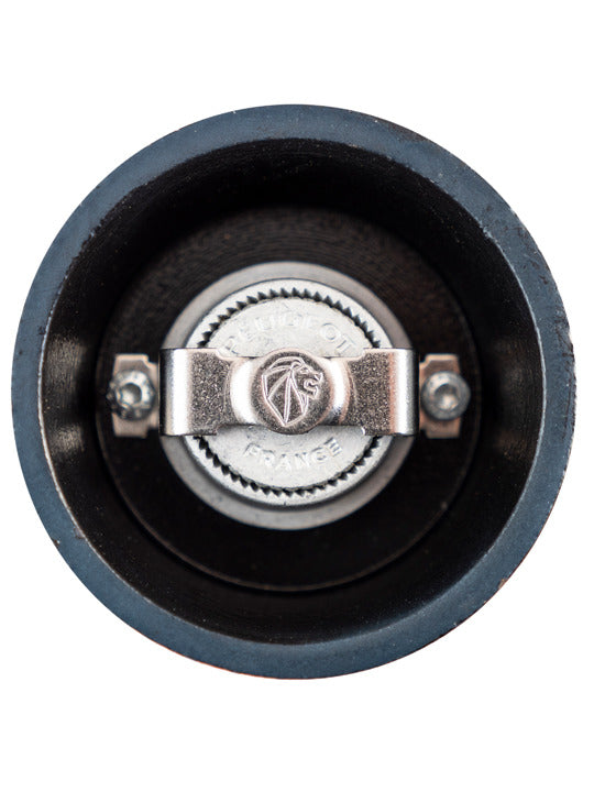 Peugeot | Bali Cast Iron Pepper Mill, Dark Blue, showcasing its metal grinding mechanism and Peugeot France lion logo, filled with Sichuan pepper for a sensory experience.