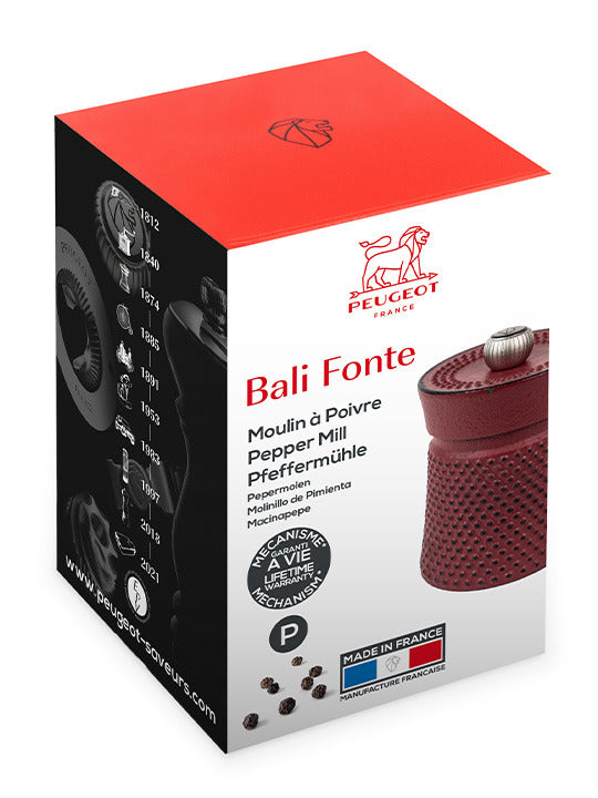 Peugeot | Bali Cast Iron Pepper Mill, Red, in packaging featuring logo, product names, lifetime guarantee badge, and Made in France label.