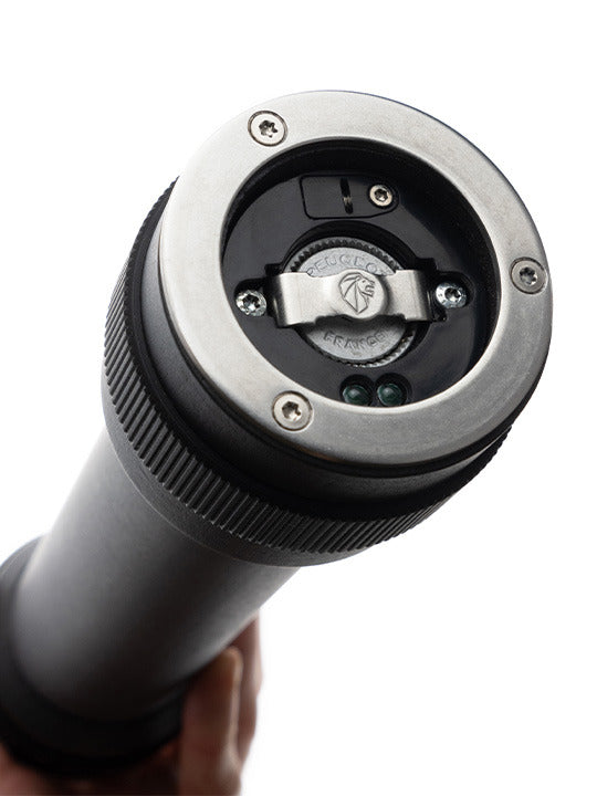 Close-up of Peugeot BBQ Pepper Mill, 12 inches, showing metal bayonet flange, locking lever, and electrical contacts for innovative outdoor cooking. Ideal for barbecue enthusiasts.