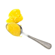 Beth's Farm Kitchen - Lemon Curd on a teaspoon, showcasing its thick, satiny texture made from fresh lemon juice, butter, and eggs. Ideal for breakfast or dessert pairing.