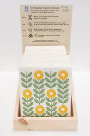 Three Bluebirds Swedish Dishcloths - Tomatoes design, featuring floral patterns, packaged in a box with an instruction card, ideal for sustainable kitchen use.