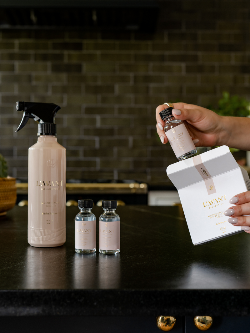 L'AVANT Collective - Multipurpose Concentrate Refill Pack of 3 Blushed Bergamot on black countertop, featuring a spray bottle, two vials, and an open box.