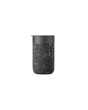 Reusable W&P Ceramic Mug in Terrazzo Charcoal, 16 oz, featuring a splash-resistant BPA-free plastic lid and a matte silicone sleeve for grip.