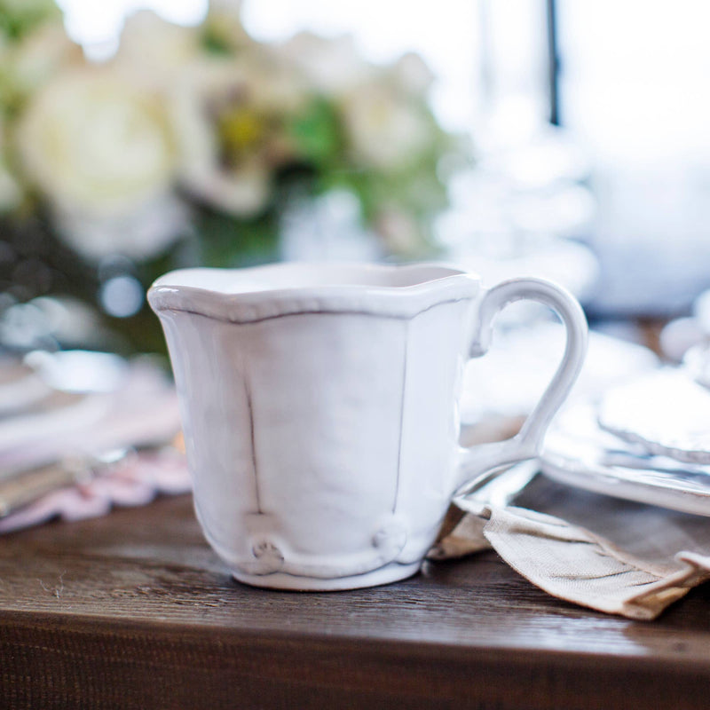 Bella Bianca Beaded Mug on table, showcasing its Italian stoneware craftsmanship with elegant beaded pattern, perfect for enhancing coffee or tea enjoyment.