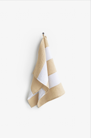 MagicLinen Striped Linen Tea Towel on hook, showcasing zero-waste design with hanging loop. Perfect for kitchen use, offering durability and absorbency.