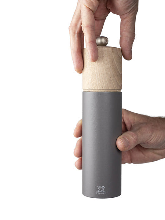 Peugeot | Boreal Pepper Mill, Rock Gray: A sleek, hand-held mill with a matte gray and natural wood design, featuring Peugeot's durable steel mechanism for rich pepper aromas.