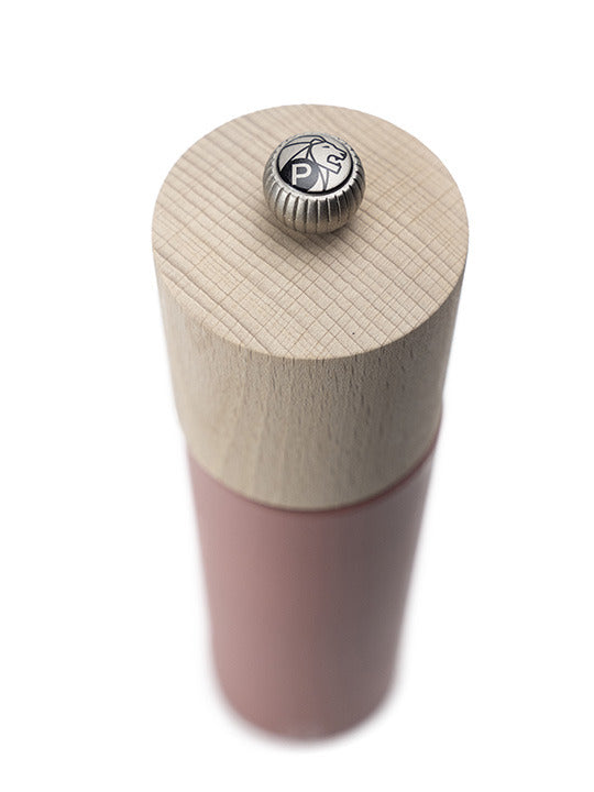 Peugeot | Boreal Pepper Mill, Hazelnut: A tall, cylindrical grinder with a natural wood top and pinkish-red body, featuring a metal knob with P and lion logo.