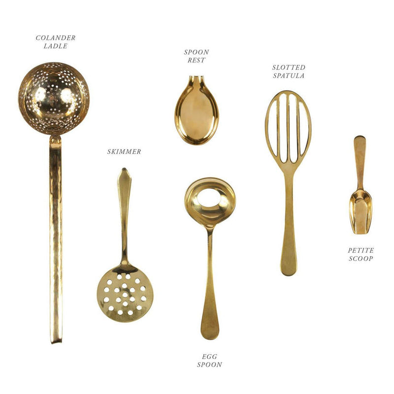 Sir|Madam Brass Spoon Rest with six gold-tone kitchen tools: Colander Ladle, Skimmer, Egg Spoon, Slotted Spatula, Petite Scoop—crafted from food-safe solid brass.