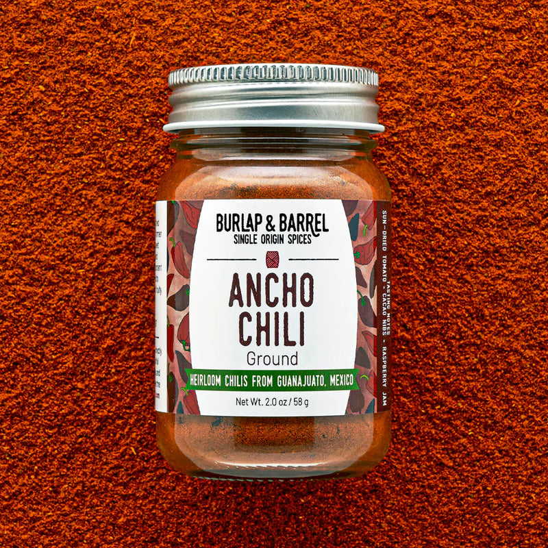 Burlap & Barrel | Ancho Chili: A glass jar of ground Ancho chili powder, offering earthy, sweet flavors ideal for enhancing moles, stews, and marinades.