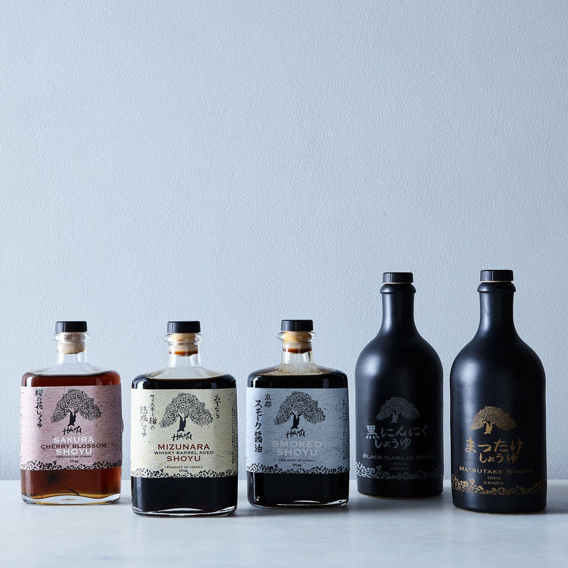 Mikuni Wild Harvest USA - Haku Smoked Shoyu, 375 ml glass bottle, showcased among liquor bottles with distinct craftsmanship and unique flavor from Kyoto.