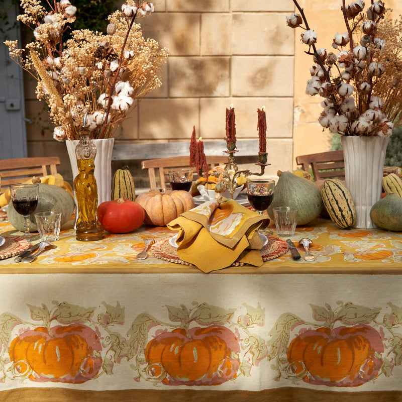 Caravan Home - Pumpkin Orange & Mustard Tablecloth: 71 x 71 drapes the table, surrounded by pumpkins, squashes, and vintage accents, capturing a warm, artisanal autumn setting.