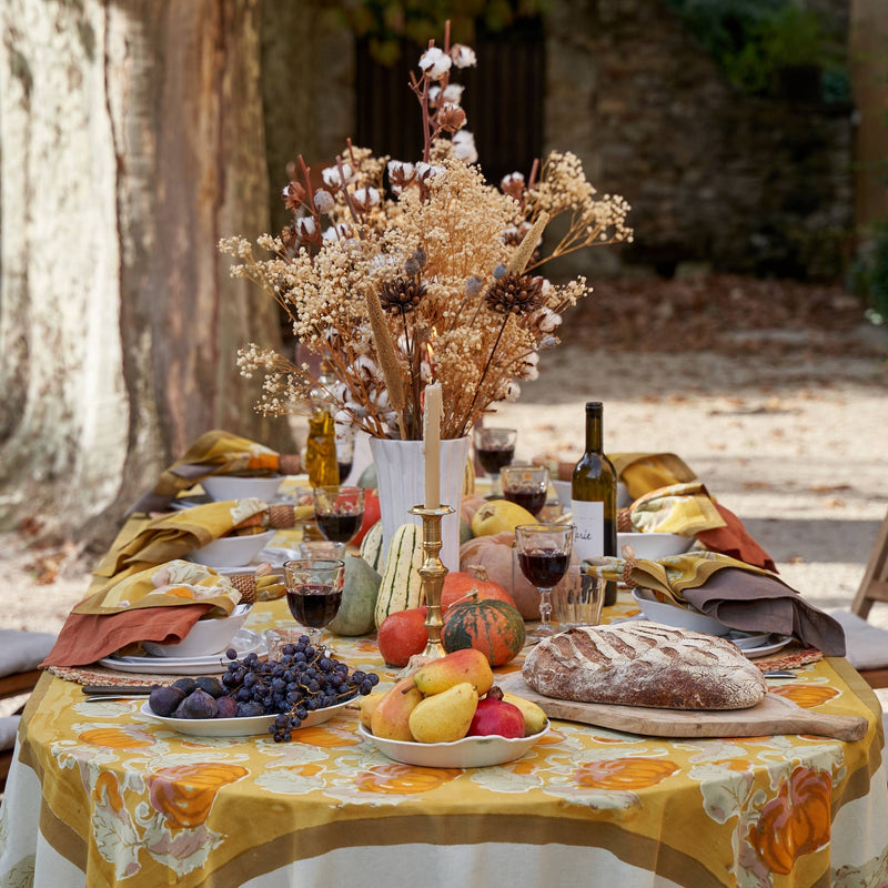 Caravan Home - Pumpkin Orange & Mustard Tablecloths: 71 x 71 elegantly styled with autumn decor, dried blooms, and a rustic bread display for a harvest-themed outdoor setting.