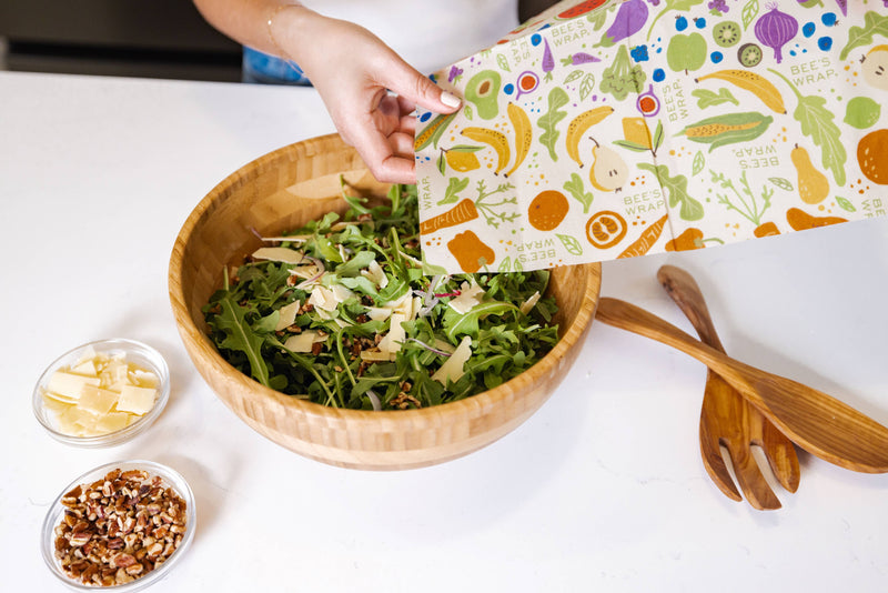 Bee's Wrap - New! Garden Party - Cut-to-Size Roll Wrap shown in use over a salad bowl, demonstrating its versatile food storage capability.