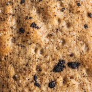 Potters Table - Cured Olive & Cracked Pepper Flatbreads, macro shot highlighting air-pockets, salt crystals, and seasoning on hand-stretched organic flatbread surface.