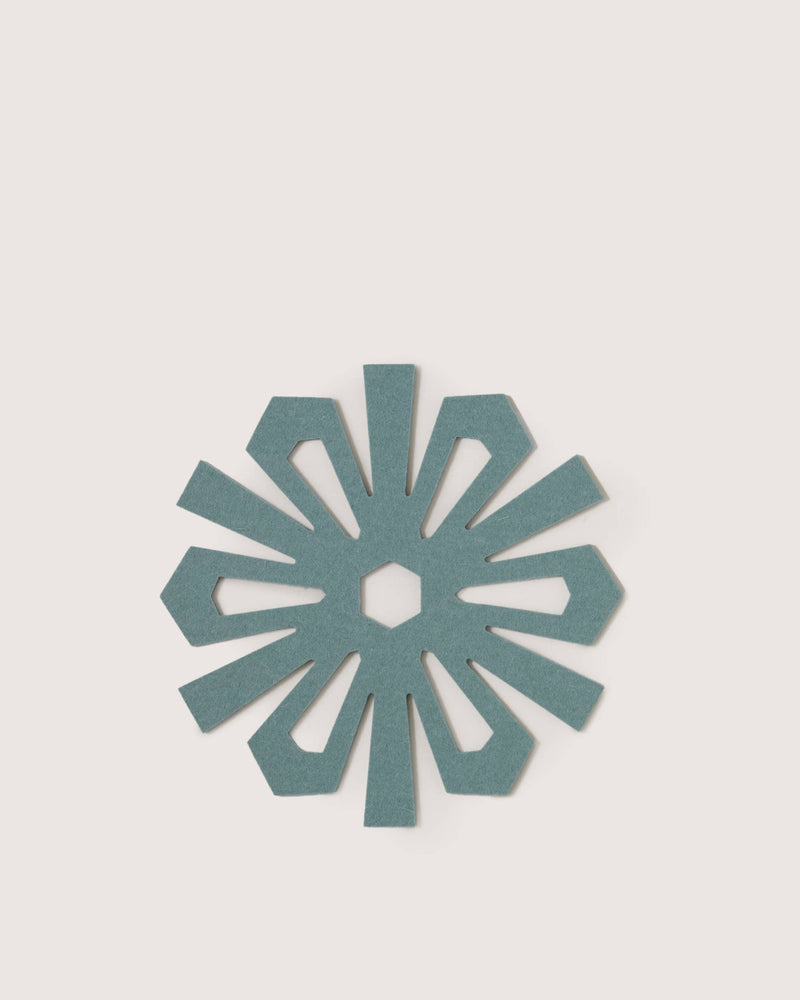 Graf Lantz - Merino Wool Snowflake Trivet - Heather Spruce, a teal felt trivet with a petal design, protects surfaces while adding elegance to your kitchen decor.