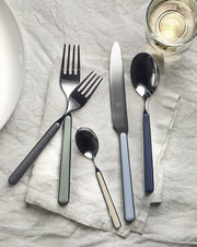Mepra SPA - PLACE SET 5 PCS FANTASIA SUNFLOWER: Grey silverware set, including fork, spoon, and knife, displayed elegantly on a napkin. Made from durable 18/10 stainless steel and resin.