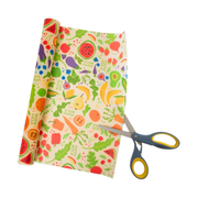 Bee's Wrap - New! Garden Party - Cut-to-Size Roll Wrap, shown being cut with scissors for versatile, reusable food storage.