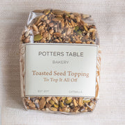 Potters Table - Top it All Off: Seeded Topping, a clear pouch of mixed toasted seeds, ideal for enhancing meals with flavor and crunch.