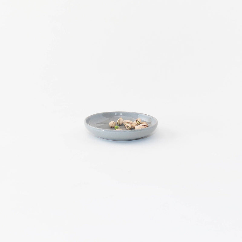 Sarah Kersten - Olive Dish: Basin Collection: Winter Mesa, showcasing a small round plate with pistachios, highlighting its versatile use for appetizers or side servings.