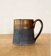 Jessica Wertz Ceramics - Black + Gold Mug, featuring a handmade two-tone glaze with metallic bronze and matte charcoal, holds 12 ounces and is dishwasher safe.