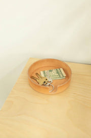 Graf Lantz - Kobon Leather Round Tray showcasing keys and money, ideal for organizing small items. Crafted from Vachetta leather for home or office use.