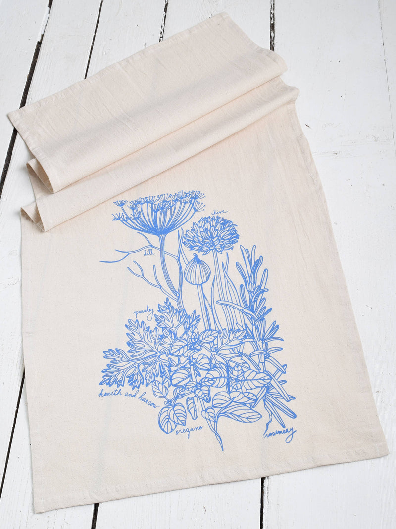 Hearth and Harrow - Kitchen Herbs Tea Towel in Blue-violet features blue flower prints on organic cotton, designed for elegance and utility in the kitchen.