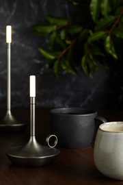 VANMOKUM | GRAYPANTS Wick Portable Rechargeable Lamp, Black: Close-up of sleek lamp on table, showcasing versatile design for intimate or bustling settings.