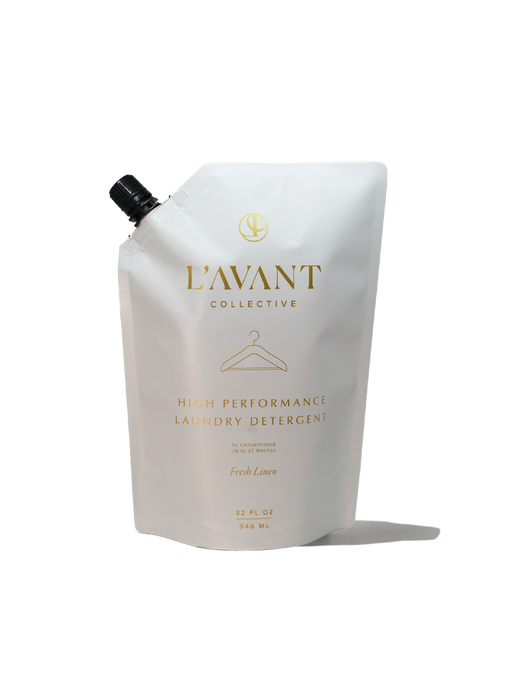 L'AVANT Collective - 32oz Laundry Detergent Refill - Fresh Linen, in a white pouch with a black cap, gold lettering, eco-friendly, concentrated formula.