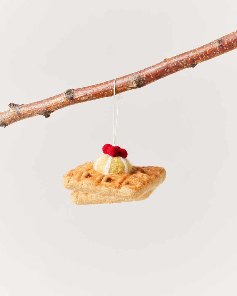 Farmhouse Pottery - Felted Breakfast Ornament: Waffle Stack, a handcrafted wool piece from Nepal, resembling a waffle with cream and berry, suspended by a string.