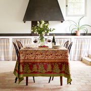 Couleur Nature - Noel Red & Green French Tablecloth: 71 x 106 drapes a cozy dining nook with festive elegance, enhancing a rustic, intimate meal setting.