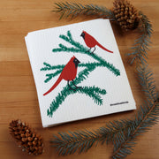 Three Bluebirds Swedish Dishcloth featuring cardinals on a bird-themed napkin, showcasing eco-friendly, reusable design ideal for kitchen cleaning tasks.