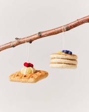Farmhouse Pottery - Felted Breakfast Ornament: Pancake Stack, handcrafted in Nepal, features wool-felt pancakes and a waffle, perfect for kitchen-themed decor.