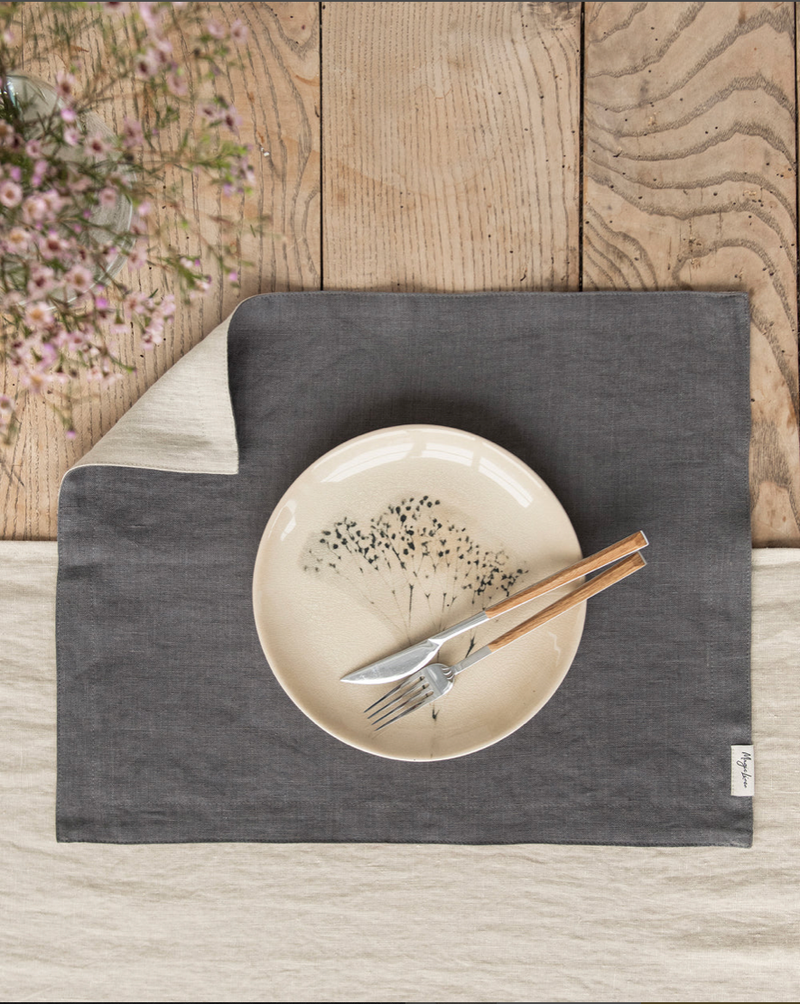 MagicLinen - Double Layer Linen Placemat Set of 2: Latte displayed with a fork and knife on a wooden table, showcasing its texture and design.