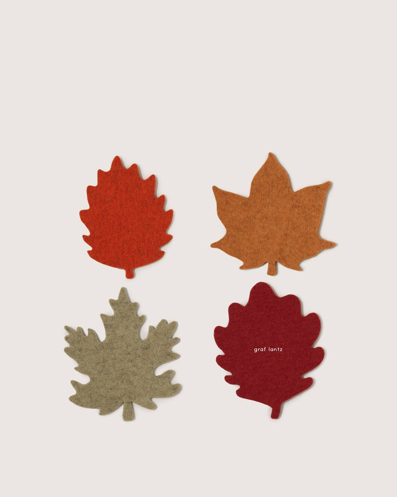 Graf Lantz - Merino Wool Autumn Leaf Coaster Multi 4 Pack, showcasing four felt leaf coasters in autumn hues, arranged neatly, embodying seasonal elegance and practical home decor.