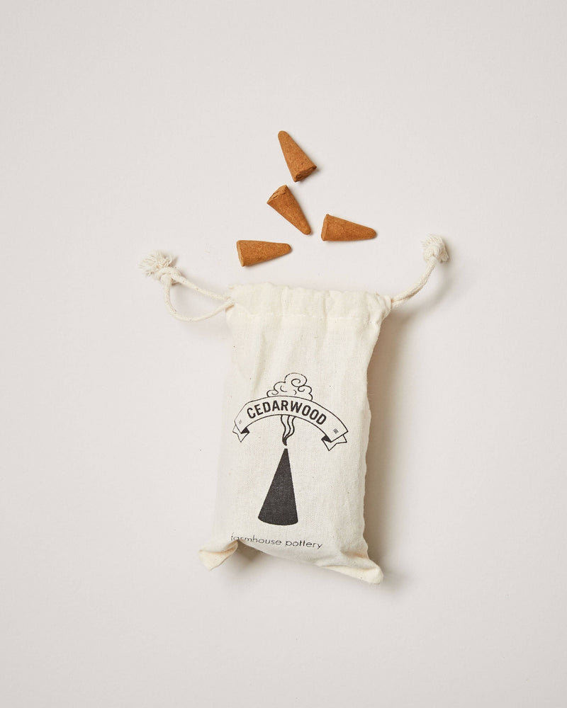 Farmhouse Pottery - Artisan Incense Cones: Cedarwood displayed in a natural-cotton pouch with five loose cones, highlighting calming aromas for a curated scent experience.
