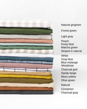 MagicLinen - Ruffle trim tea towel stack, showcasing colorful linen fabrics, ideal for stylish kitchen use.
