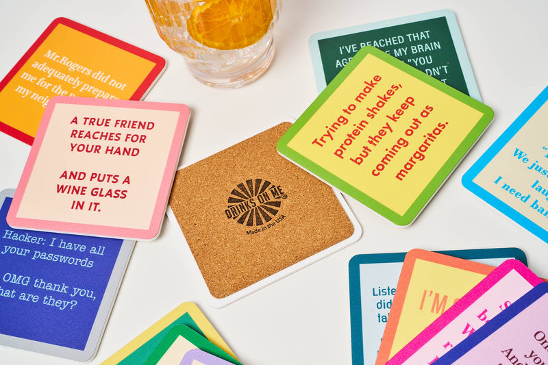 Drinks on Me - COASTER Drive Home features humorous resin coasters with cork backing, perfect for protecting surfaces while adding playful charm to home bars.