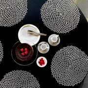 Chilewich | Dahlia Placemats - Gunmetal elegantly displayed under a chocolate cake with raspberries, enhancing the table's sophisticated and practical dining aesthetic.