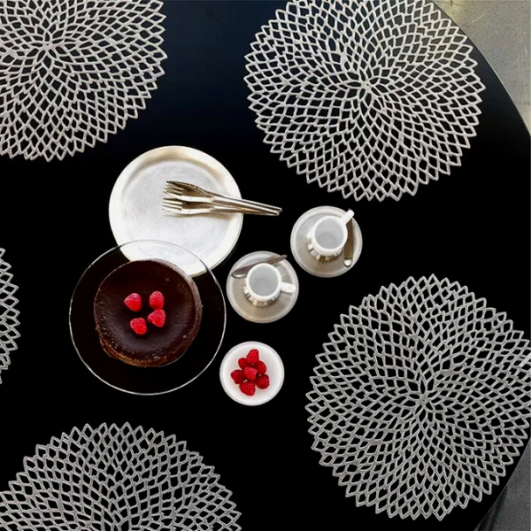 Chilewich | Dahlia Placemats - Gunmetal elegantly displayed under a chocolate cake with raspberries, enhancing the table's sophisticated and practical dining aesthetic.