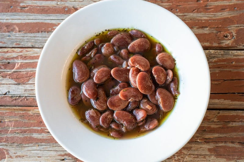 Rancho Gordo Christmas Lima Beans in a sauce, showcased in a bowl, ideal for enhancing culinary creations available at Athens Cooks.