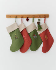 MagicLinen | Gingerbread Man Embroidered Christmas Stocking hanging on a peg rail, showcasing festive embroidery, part of a sustainable, zero-waste holiday decor collection.