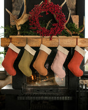 MagicLinen's handcrafted linen Christmas stocking features a soft, double-layer design with a hanging loop, perfect for adding sustainable charm to your holiday decor.
