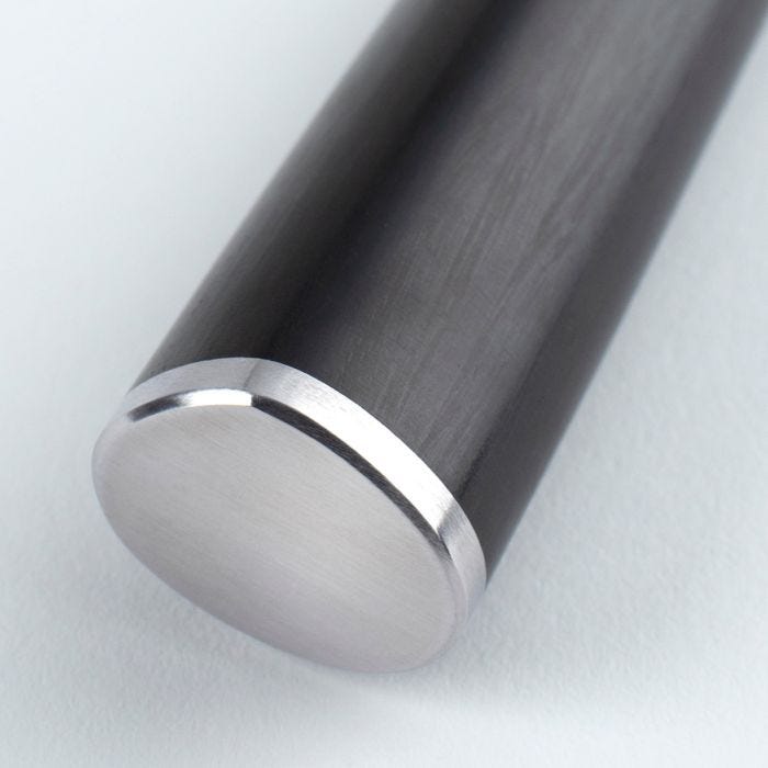 Close-up of Shun Classic Offset Bread Knife's polished metal end cap, highlighting its ergonomic design for improved knuckle clearance and precise cutting.
