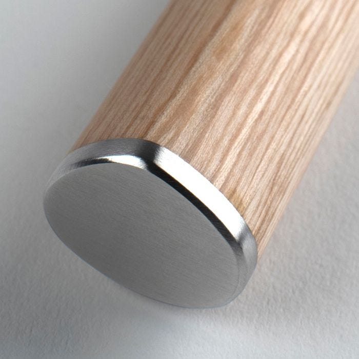 Close-up of Shun Classic Blonde Bread Knife with a turned wooden handle, capped with brushed stainless steel, showcasing its elegant craftsmanship and durable, balanced design.