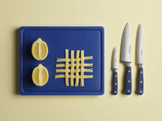 Wüsthof Classic 3 1/2 Paring Knife Wild Blueberry displayed on a cutting board with lemons, emphasizing its precision and craftsmanship.